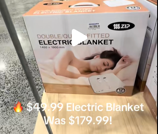 Boxed Zip brand double/queen electric blanket on a store display; packaging shows a sleeping woman and a small controller image on the box.